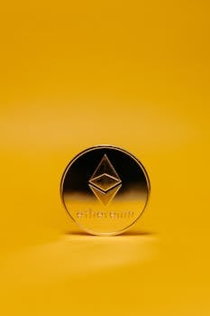 A close-up of Ethereum cryptocurrency coin on a vibrant yellow backdrop symbolizing digital finance innovation.