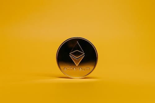 Free Ethereum Coin on Yellow Background Stock Photo