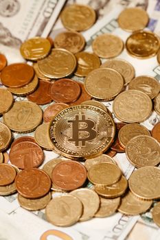 A golden Bitcoin placed among currency coins symbolizes digital and traditional finance.