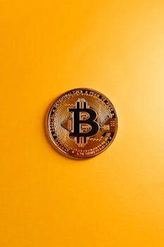 A detailed shot of a Bitcoin coin resting on a bold yellow surface, symbolizing digital currency.
