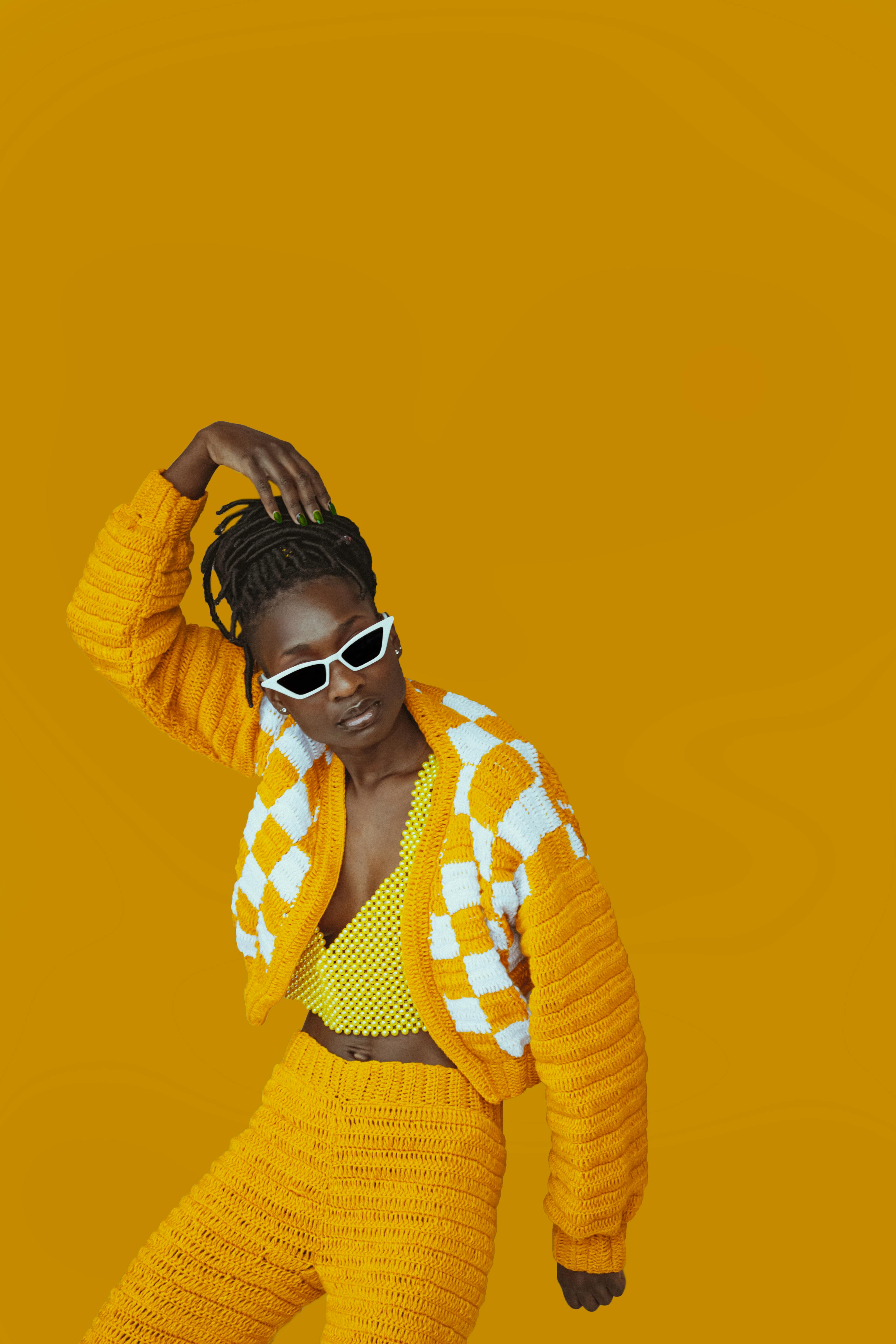 model in a yellow outfit on a yellow background