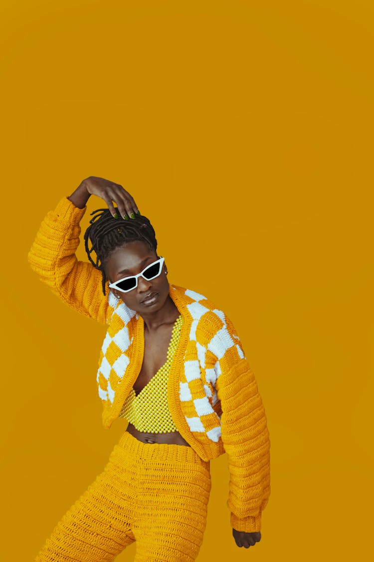 Model In A Yellow Outfit On A Yellow Background 