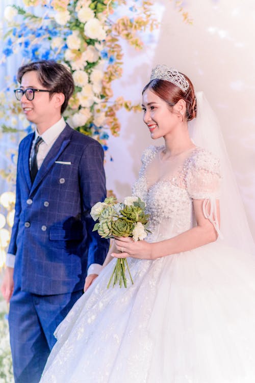 Smiling Newlyweds in Wedding Dress and Suit