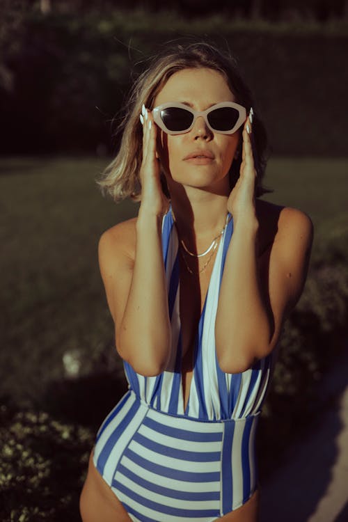 Model Posing in a Swimming Costume and Sunglasses