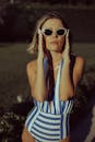 Model Posing in a Swimming Costume and Sunglasses