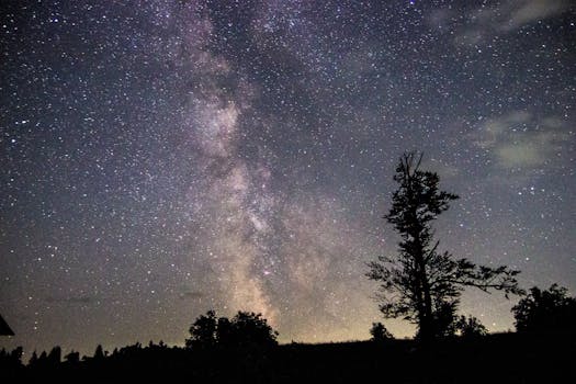 Capture of the Milky Way galaxy shining over a scenic landscape in Lunca Bradului, Romania.