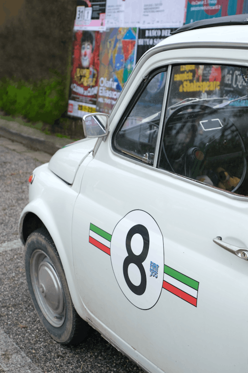 White Classic Car Parked on Concrete Pavement