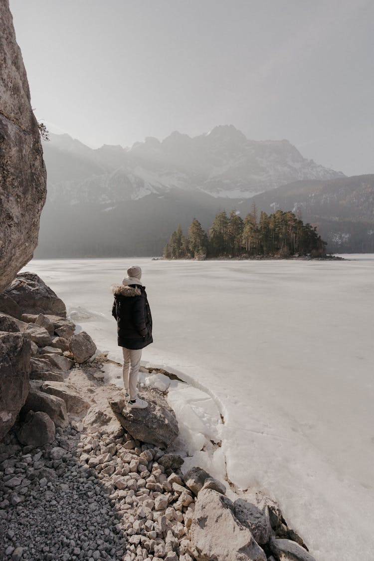 Photo Of A Woman Standing On The Edge Of The Glacier Mountain Lake