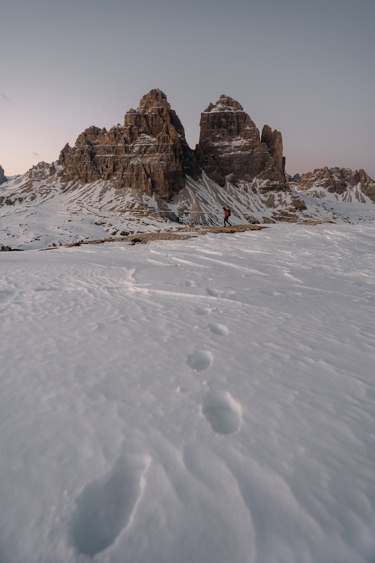 Photo Of A Snowed Mountains Landscape And A Hiking Man