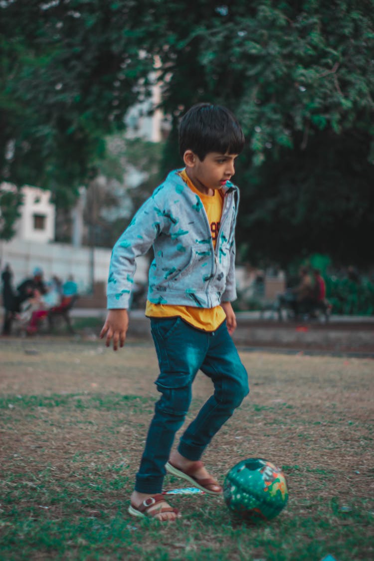 Boy Playing With A Ball