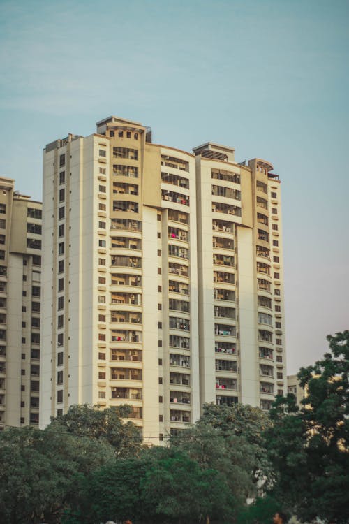 Clear Sky over Building with Aaprtments in Town