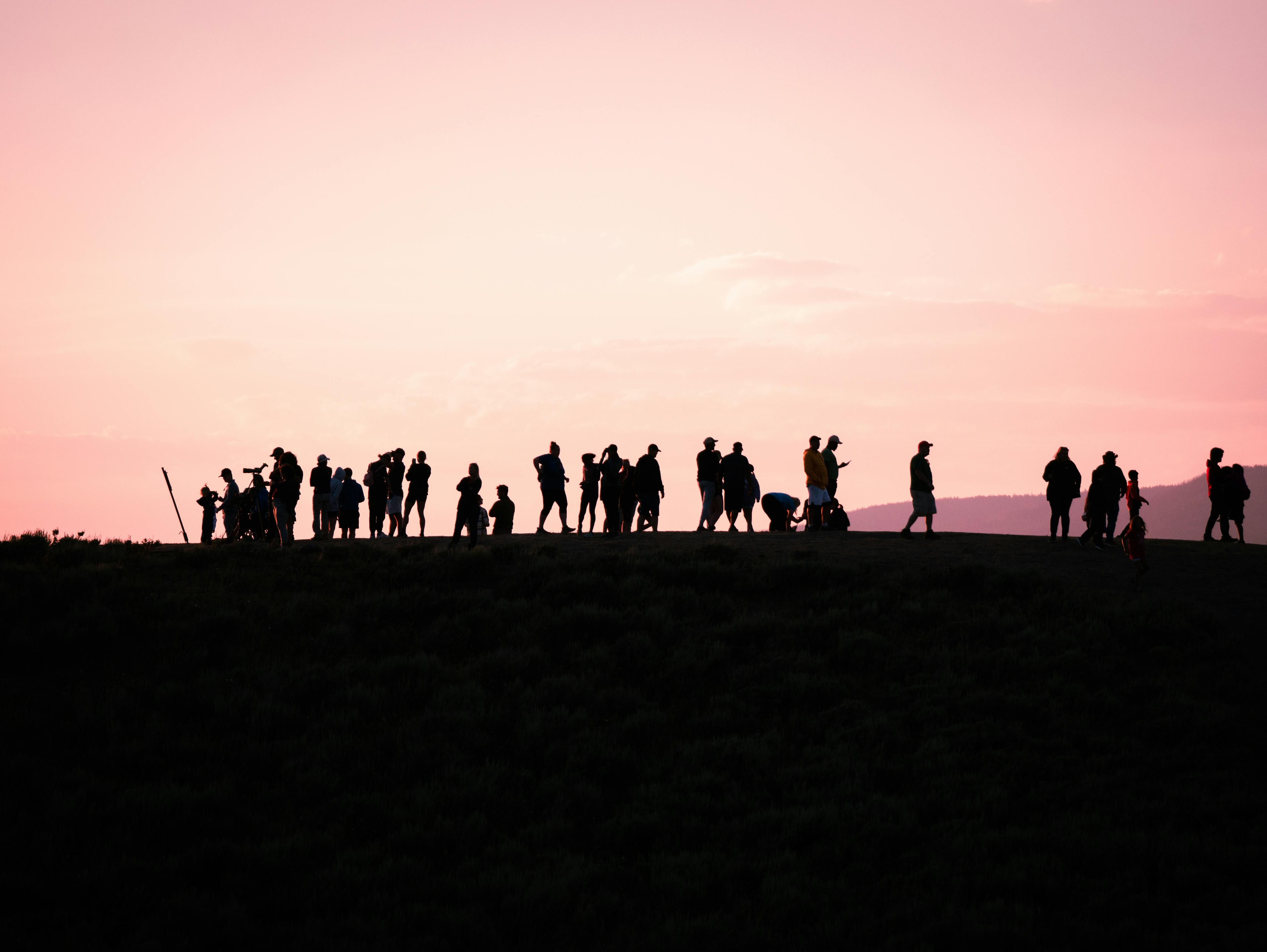 Silhouettes Of People Walking On Road Against Sunset Free Stock Photo facebook