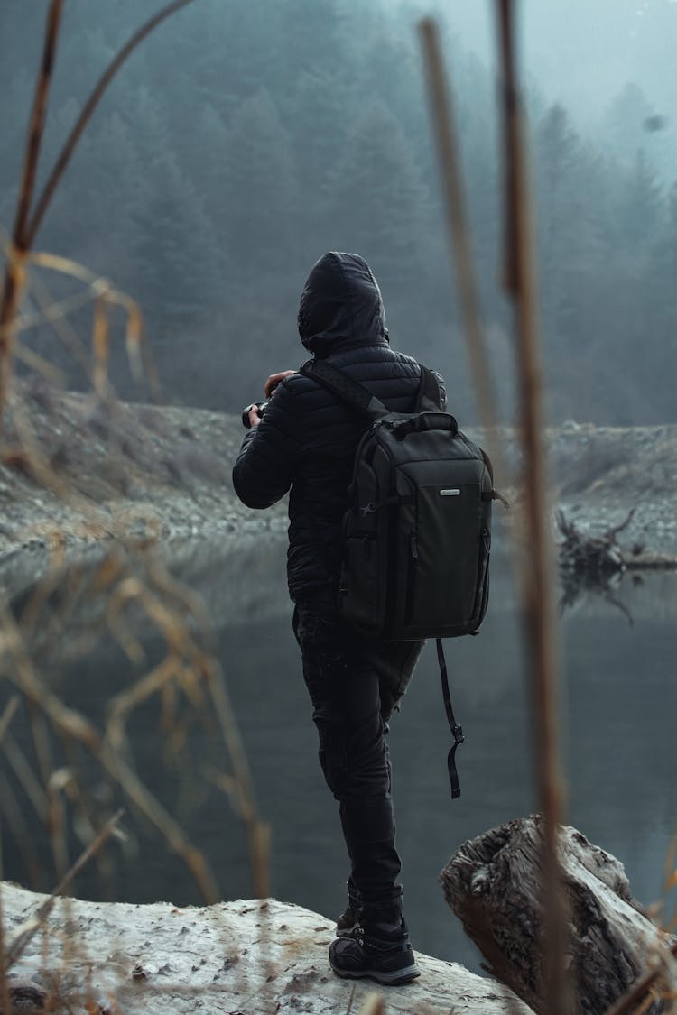 Back View Of A Photographer In A Black Jacket