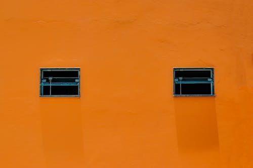 Windows on Orange Building Wall