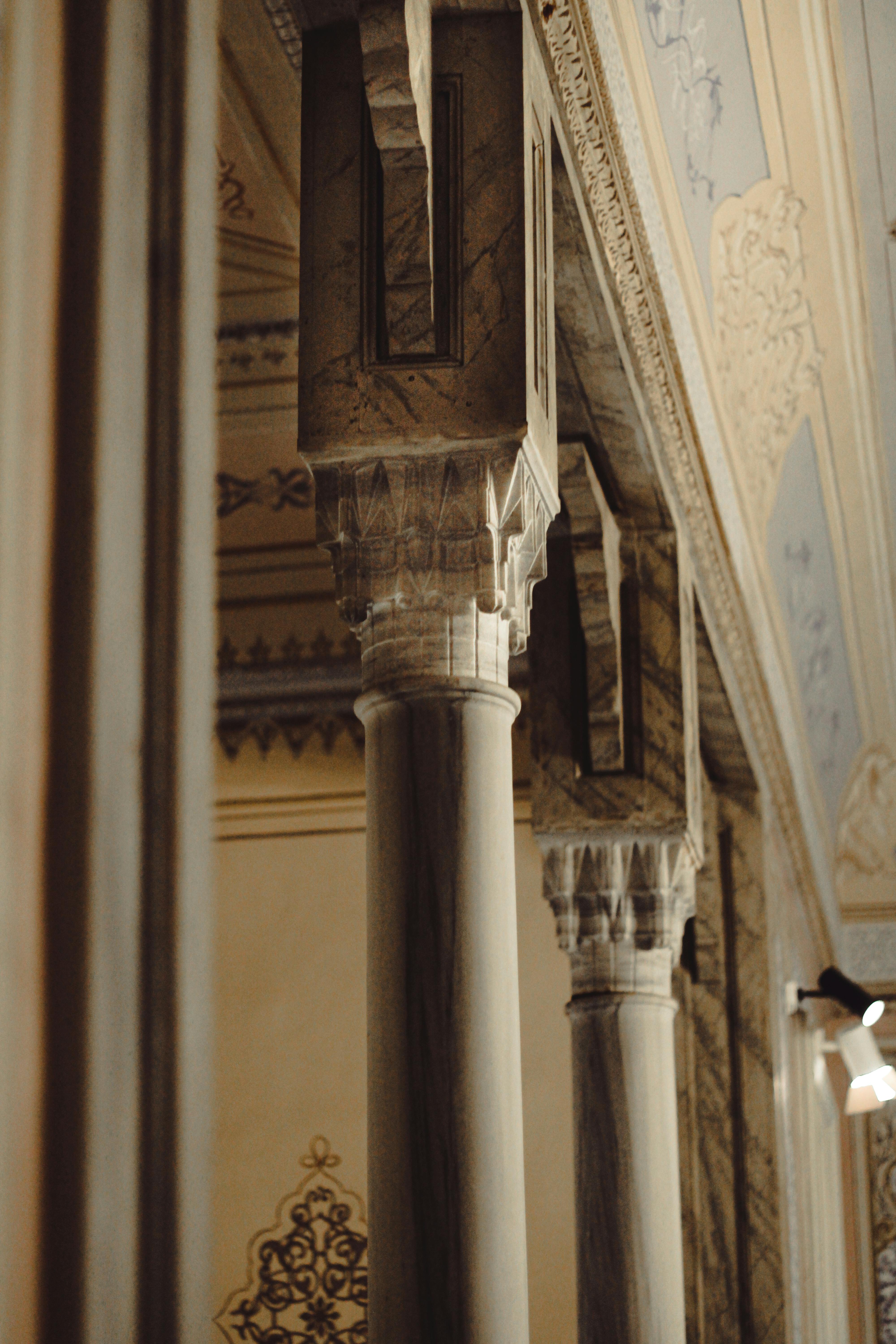Columns near Ornamented Wall · Free Stock Photo