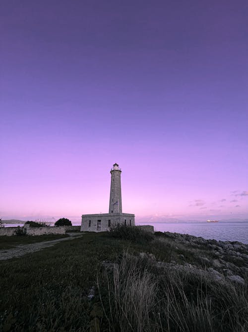 Purple Sky over Lighthouse on Sea Shore