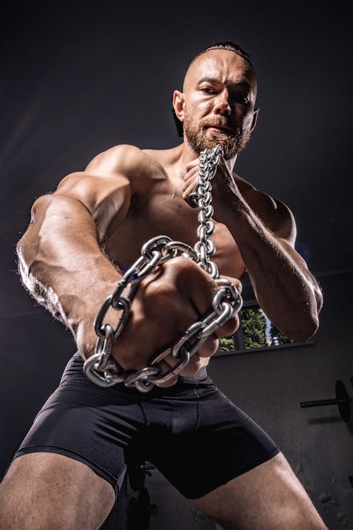 A Bodybuilder Holding a Chain 