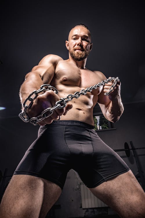 Low Angle Shot of a Man Holding a Chain 
