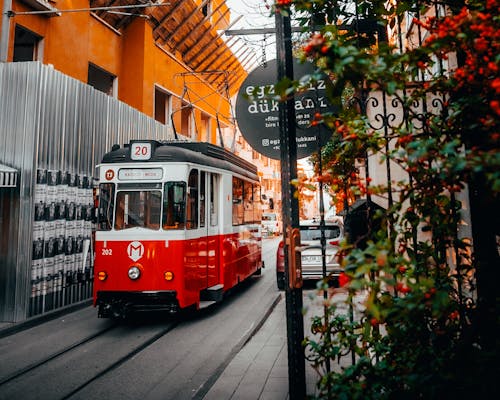 Red Tram Parked Beside a Building