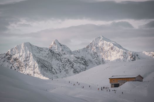 Breathtaking snow-covered peaks and cabin in Warth, Austria with a winter ambiance.