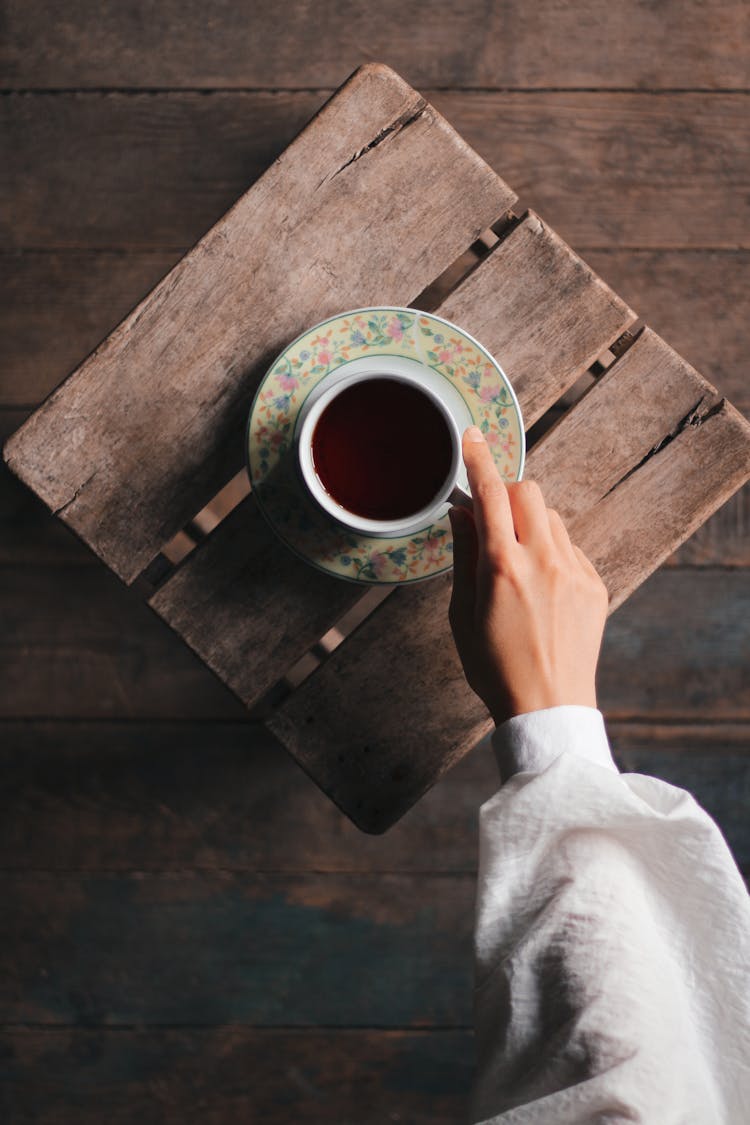 Woman Holding A Cup Of Tea 