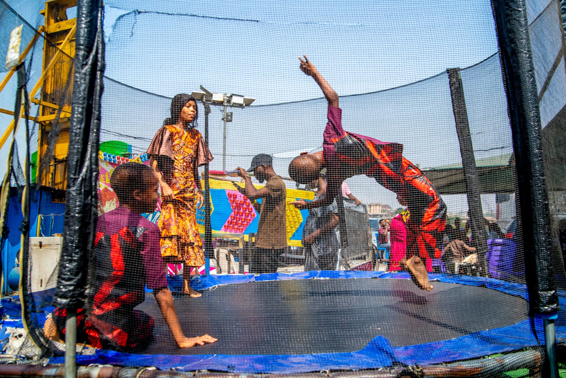 trampoline rental for parties egypt — Joyful scene of children playing energetically on a trampoline in Ibadan, Nigeria.
