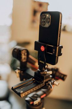 Close-up of a smartphone on a tripod setup, perfect for capturing stable shots.
