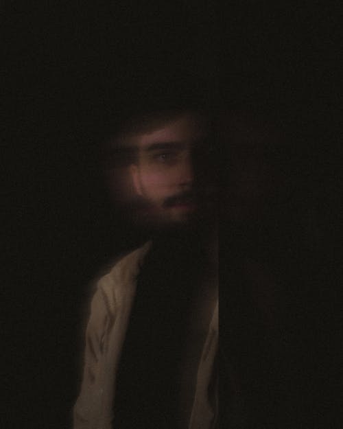 Blurred Portrait of Man on Black Background