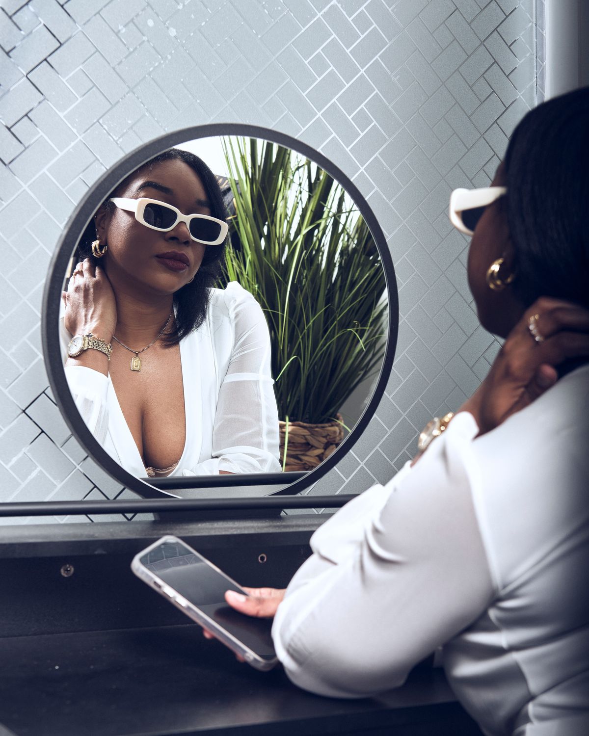A Woman in Sunglasses Looking in the Mirror · Free Stock Photo