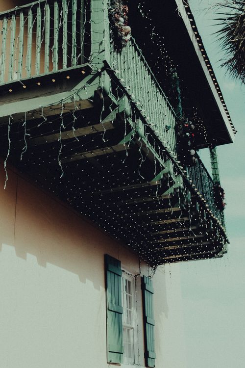 Free Low-angle view of a balcony adorned with lights, perfect for festive seasons. Stock Photo