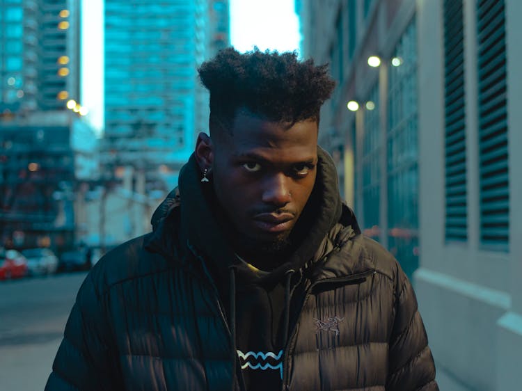 Young Man In Black Clothes In City 