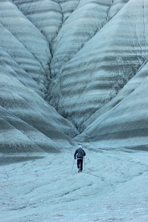 Photo of a Man Trekking in Snowed Mountains