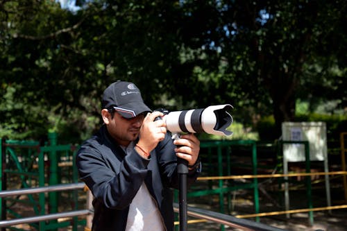 Photographer Using a Long Range Zoom Lens Camera