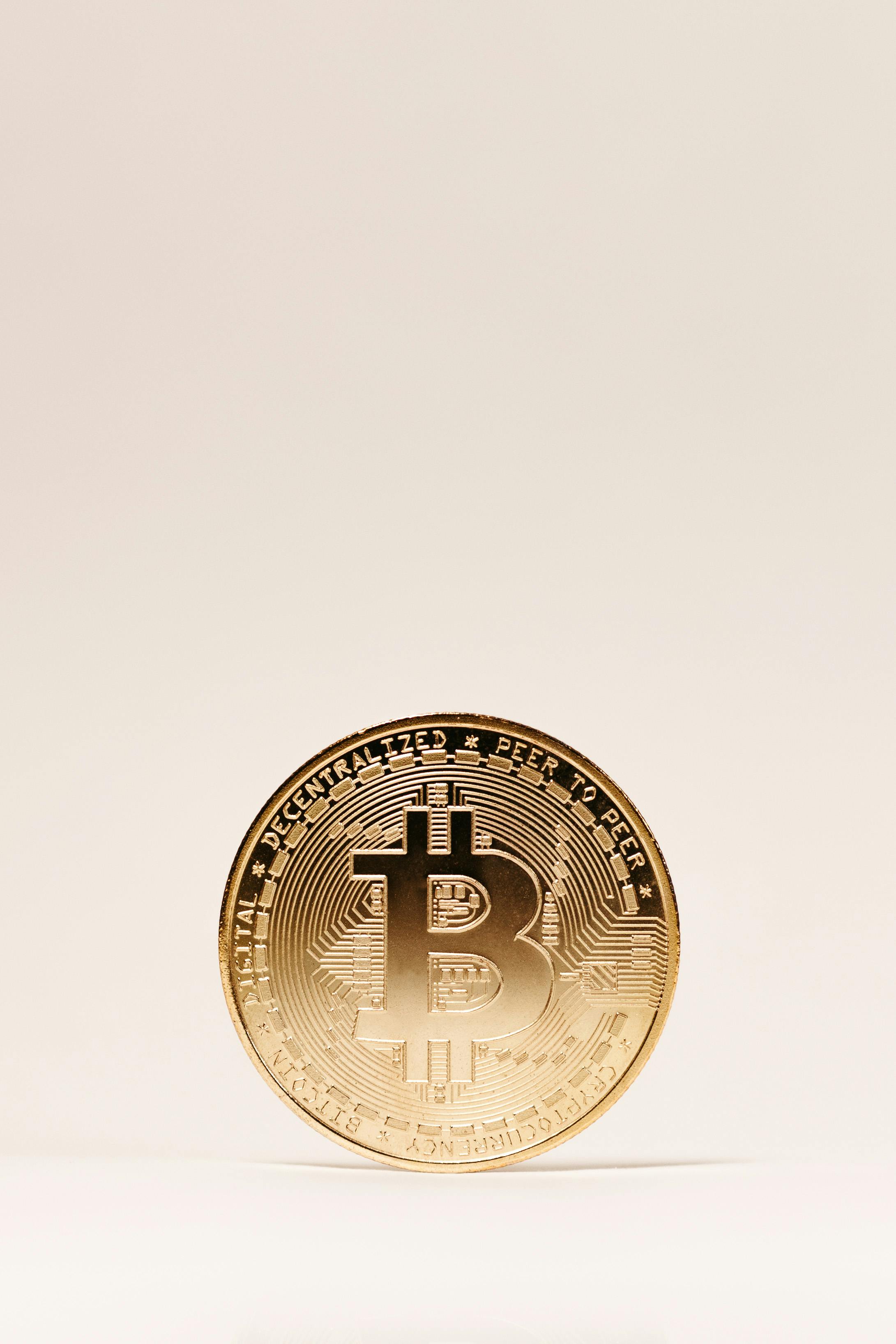 a bitcoin on beige background