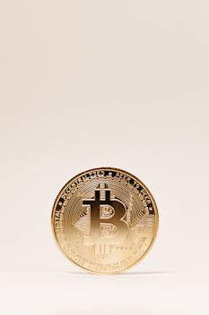 Minimalist image of a Bitcoin standing on a beige background, symbolizing cryptocurrency and wealth.