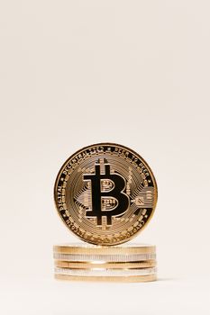 Vertical shot of a stack of Bitcoin coins emphasizing cryptocurrency and digital finance.