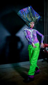 Artistic performer with vibrant costume and body paint in Mexico City.