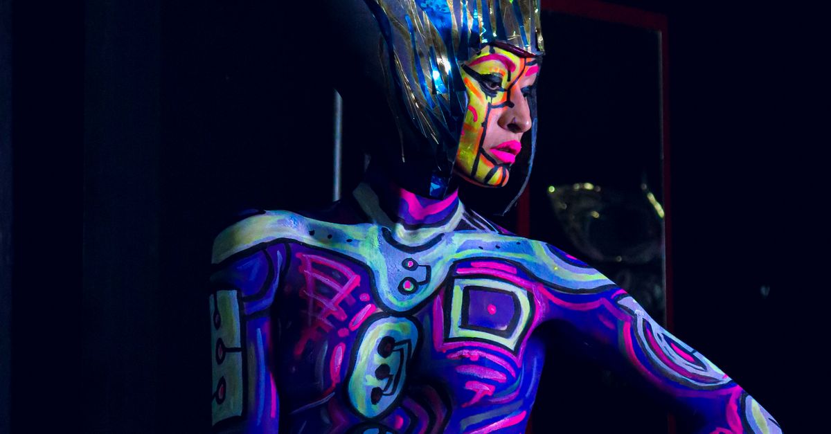 Colorful Body A woman with a colorful body painted on her body · Free Stock Photo