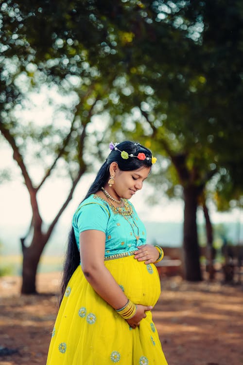 A Happy Pregnant Woman Holding Her Tummy