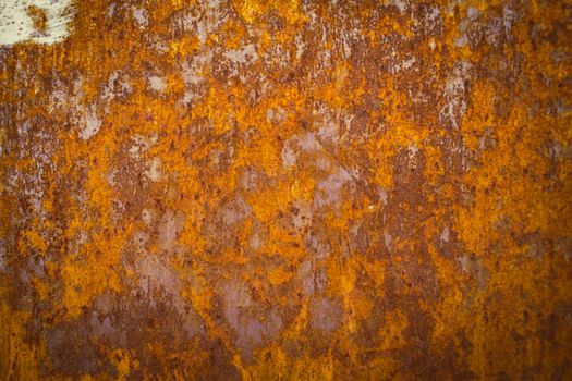 Close-up of a rusty metal surface showcasing orange and brown patina. Perfect for abstract background use.