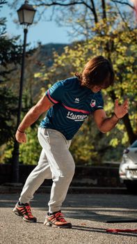 A man in sportswear exercising outdoors on a sunny day, emphasizing fitness.