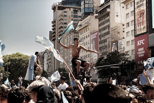 Photo of a Crowd Waving Flags and Celebrating in the Streets of Argentina
