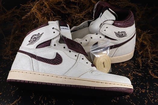 Close-up of stylish white and maroon sneakers showcasing modern footwear design.