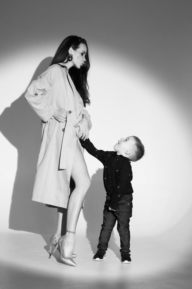 Woman In Coat And Child In Studio