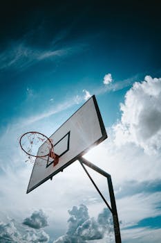 Dramatic shot of a basketball hoop under a vibrant sky in Mirassol, Brazil.
