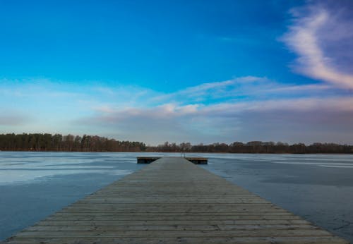 Wooden Dock on the Lake under the Cloudy Blue Sky
