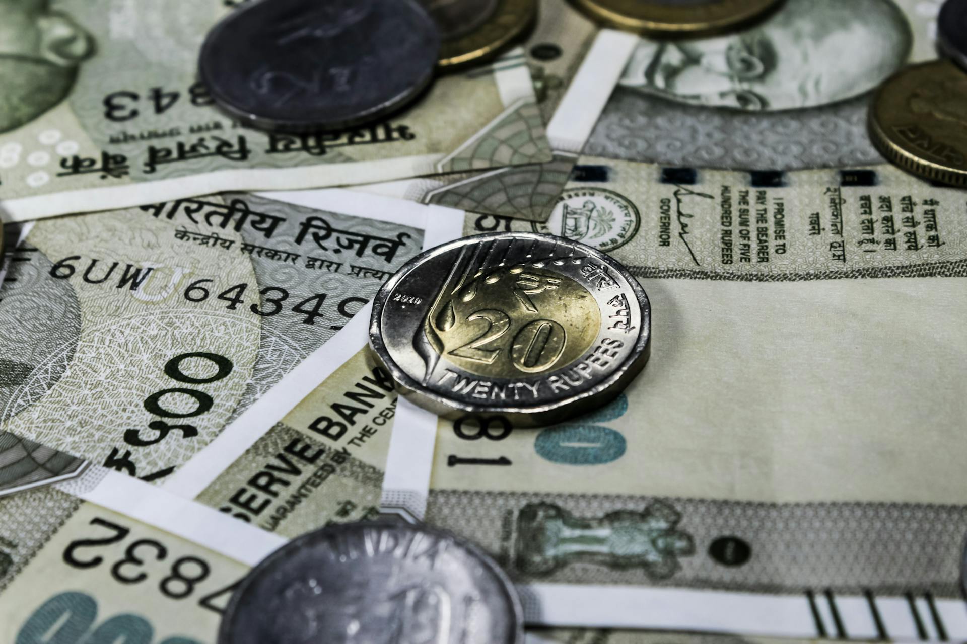 Detailed view of Indian rupee banknotes and coins, showcasing currency and finance concepts.