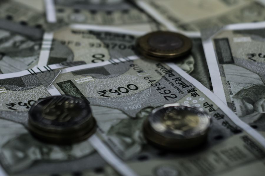 Detailed view of Indian currency notes and coins representing wealth and finance.