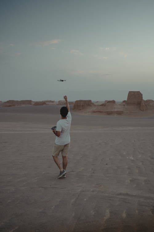 Man with Drone on Desert