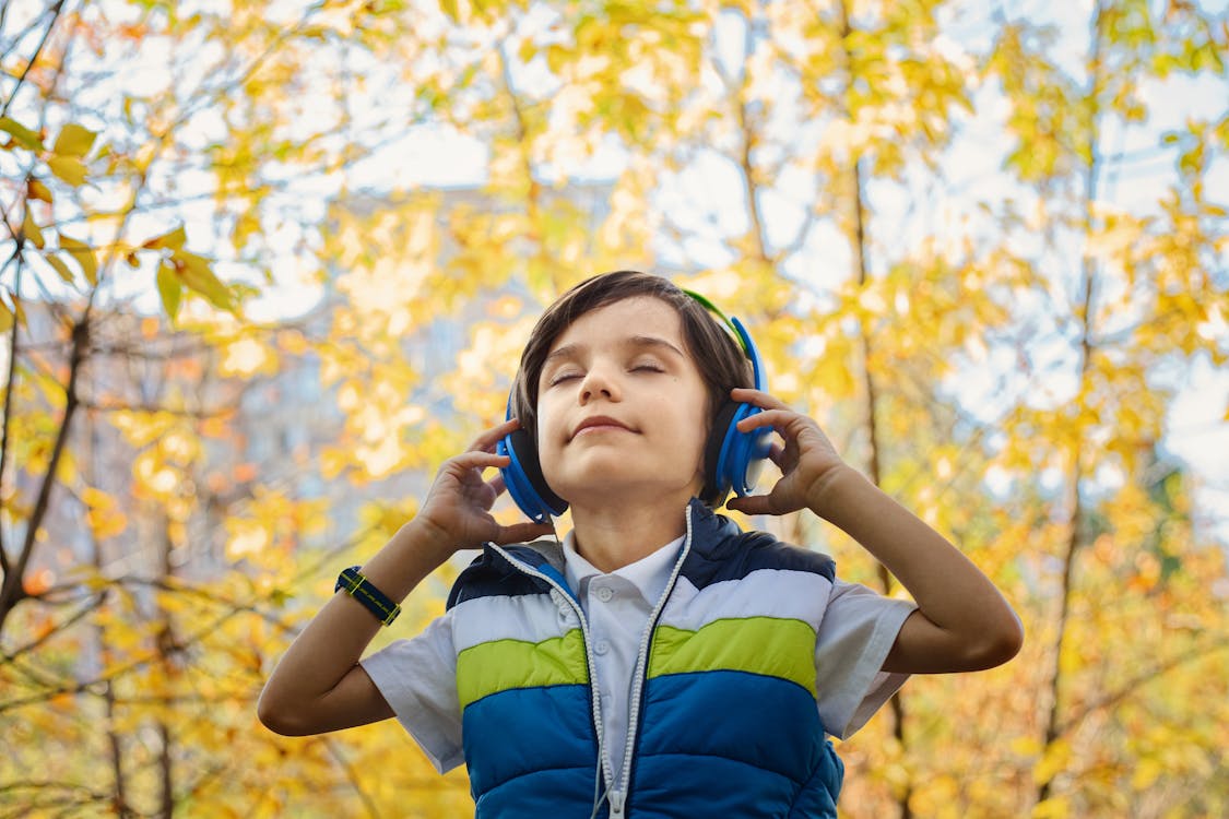 Free Photo of a Boy Listening in Headphones Stock Photo